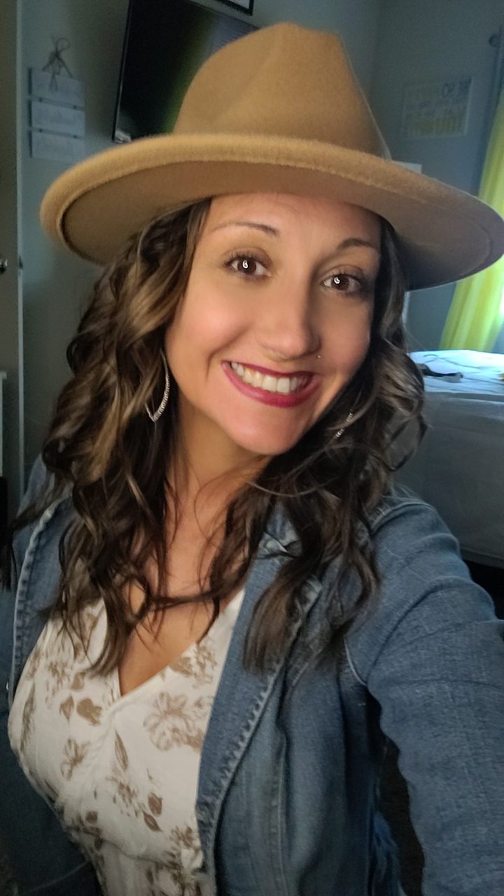 Janell Cimino, founder of Janell by the Well Ministries, smiling in a tan hat